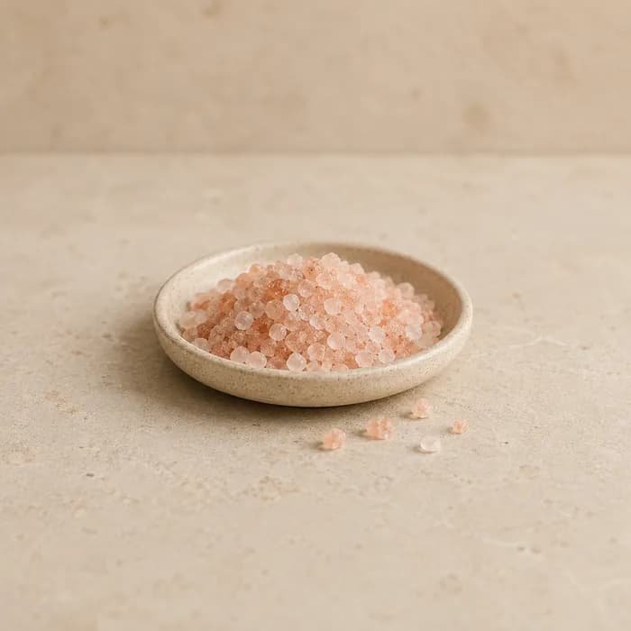 A small dish of coarse pink Himalayan salt crystals